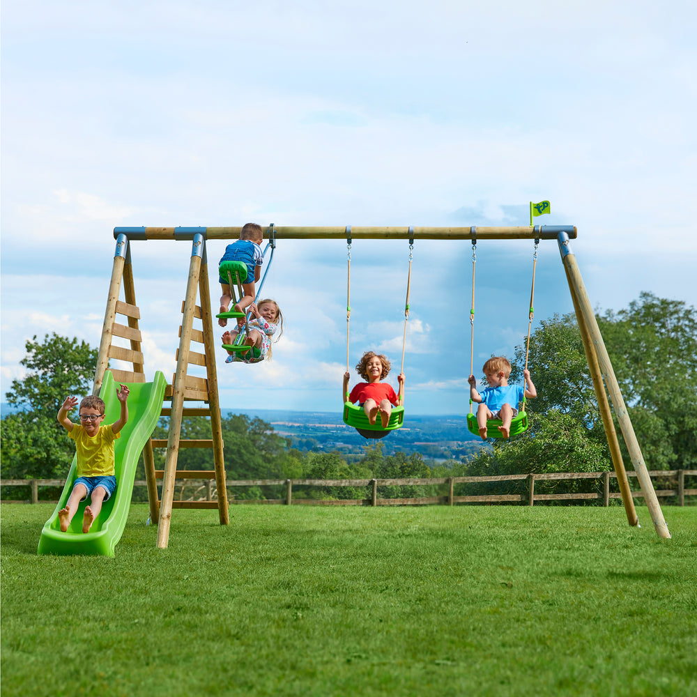 Children playing on a wooden swing and slide set