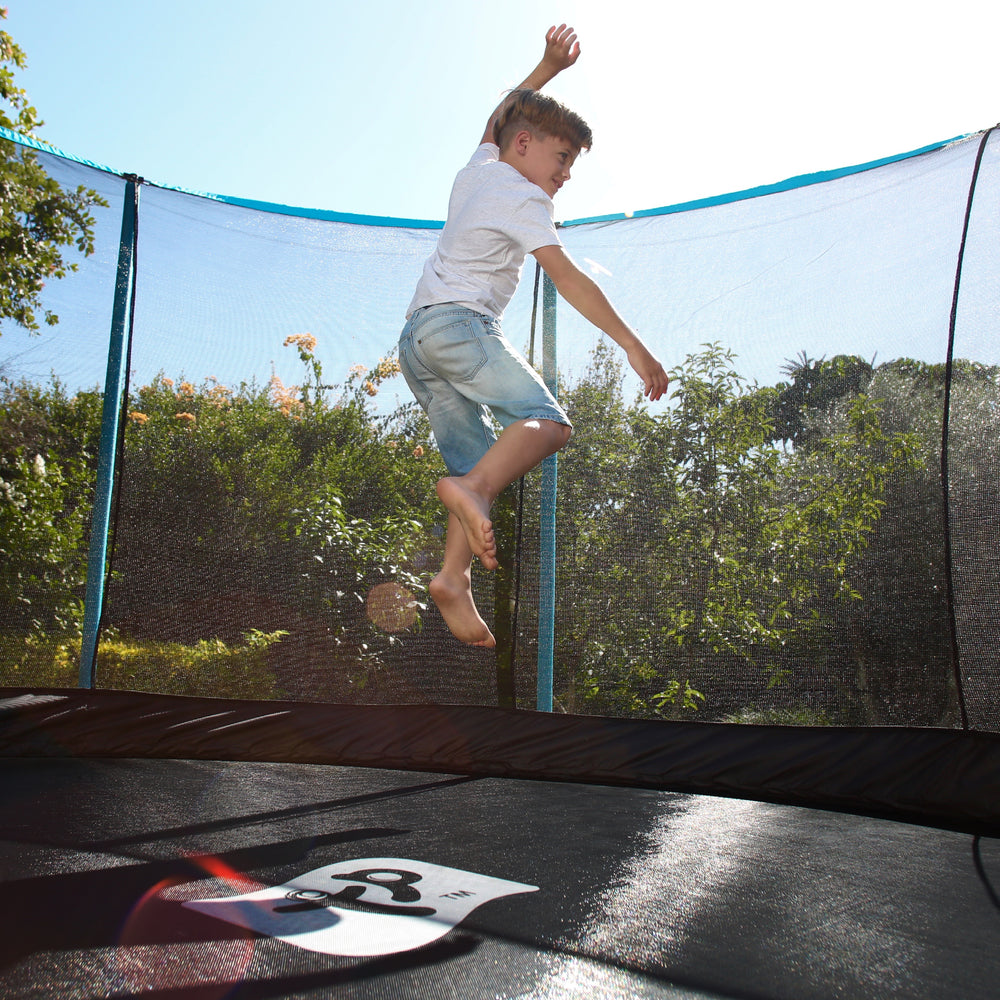 child jumping on a 10ft Genius round trampoline