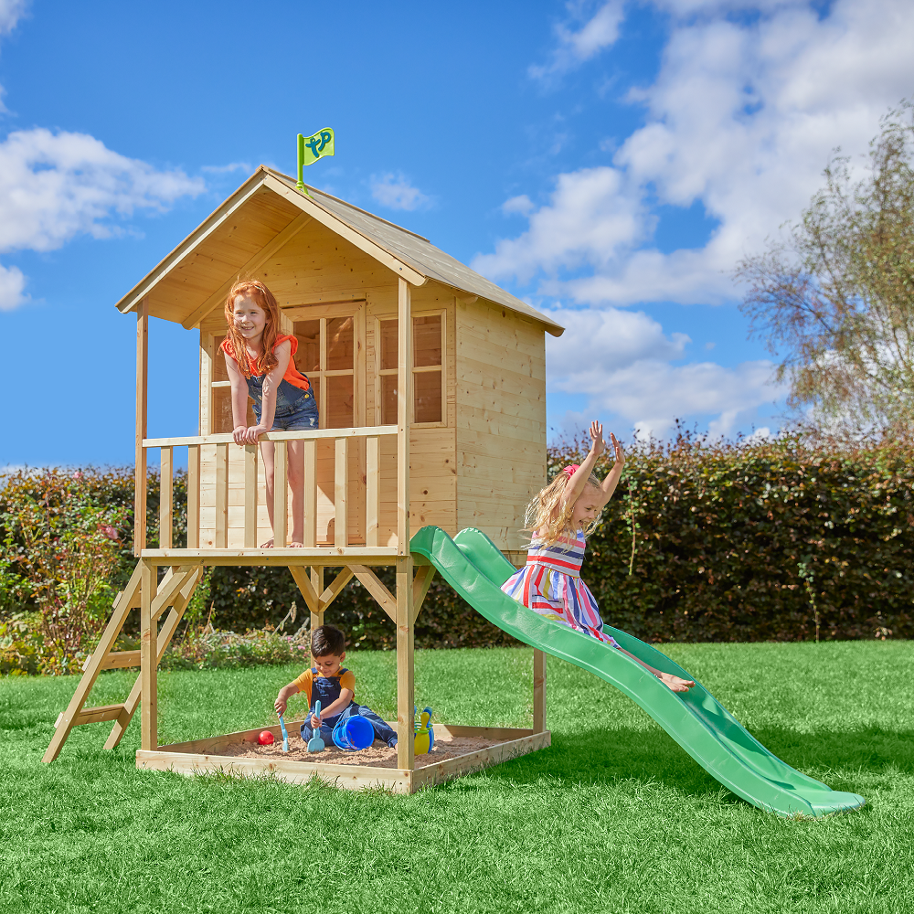 Children playing on two storey wooden playhouse