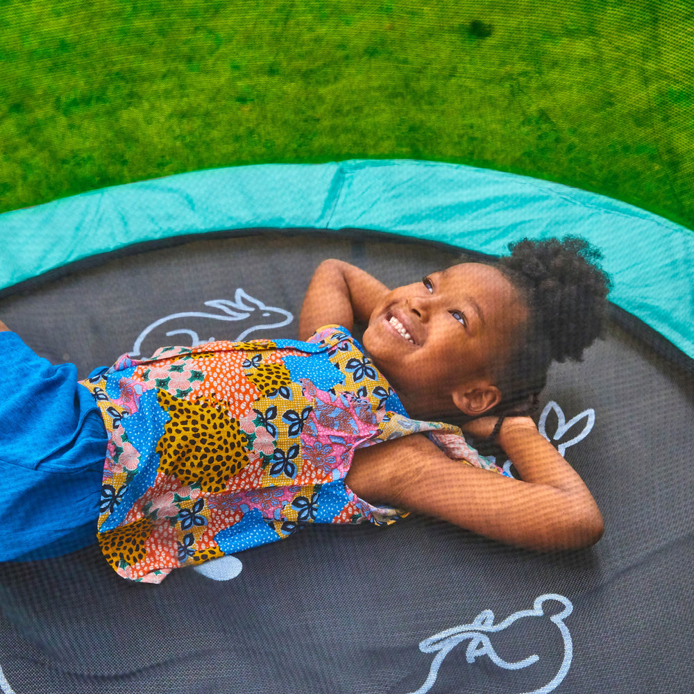 Child laying on TP 4.5ft trampoline
