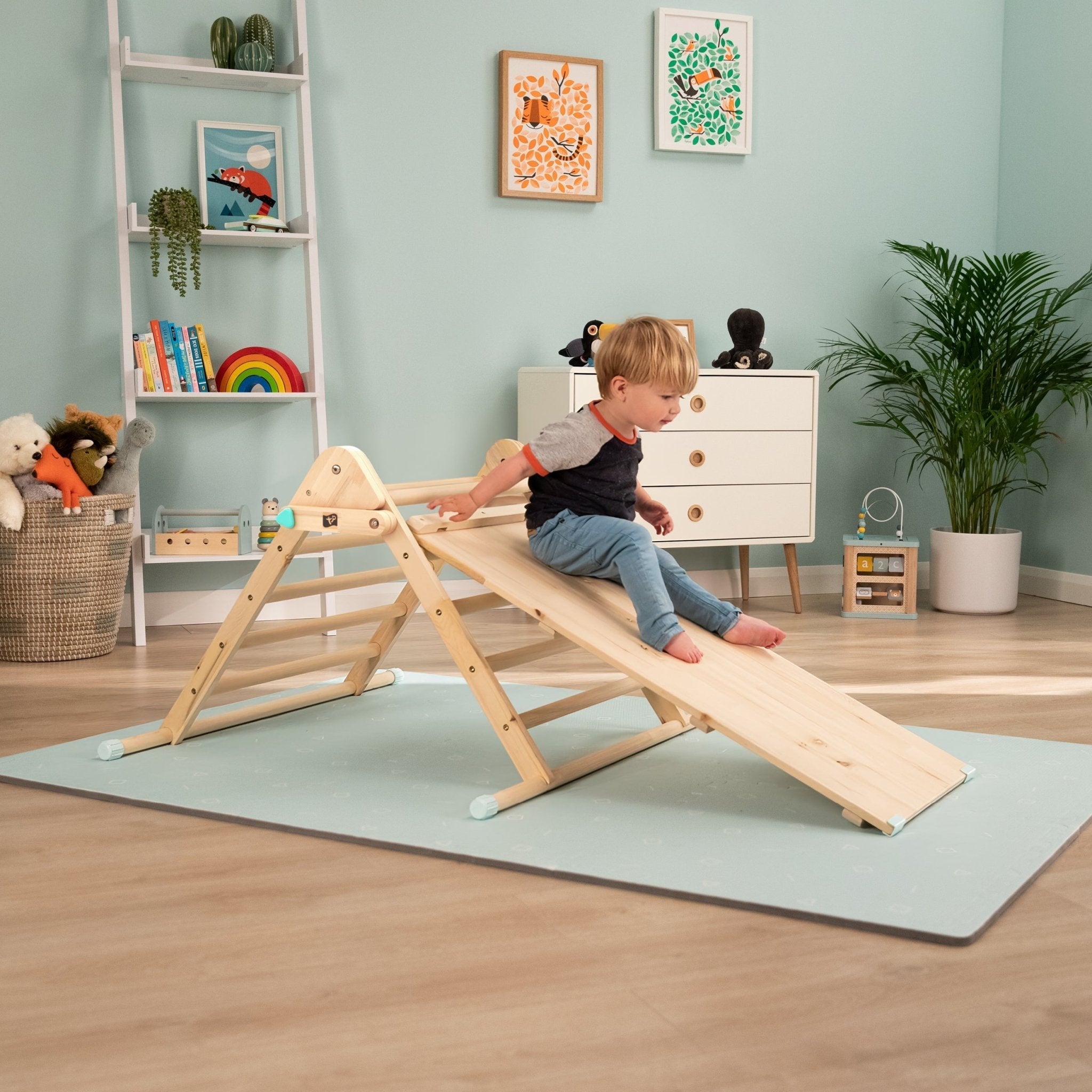  Child playing on Pikler triangle 