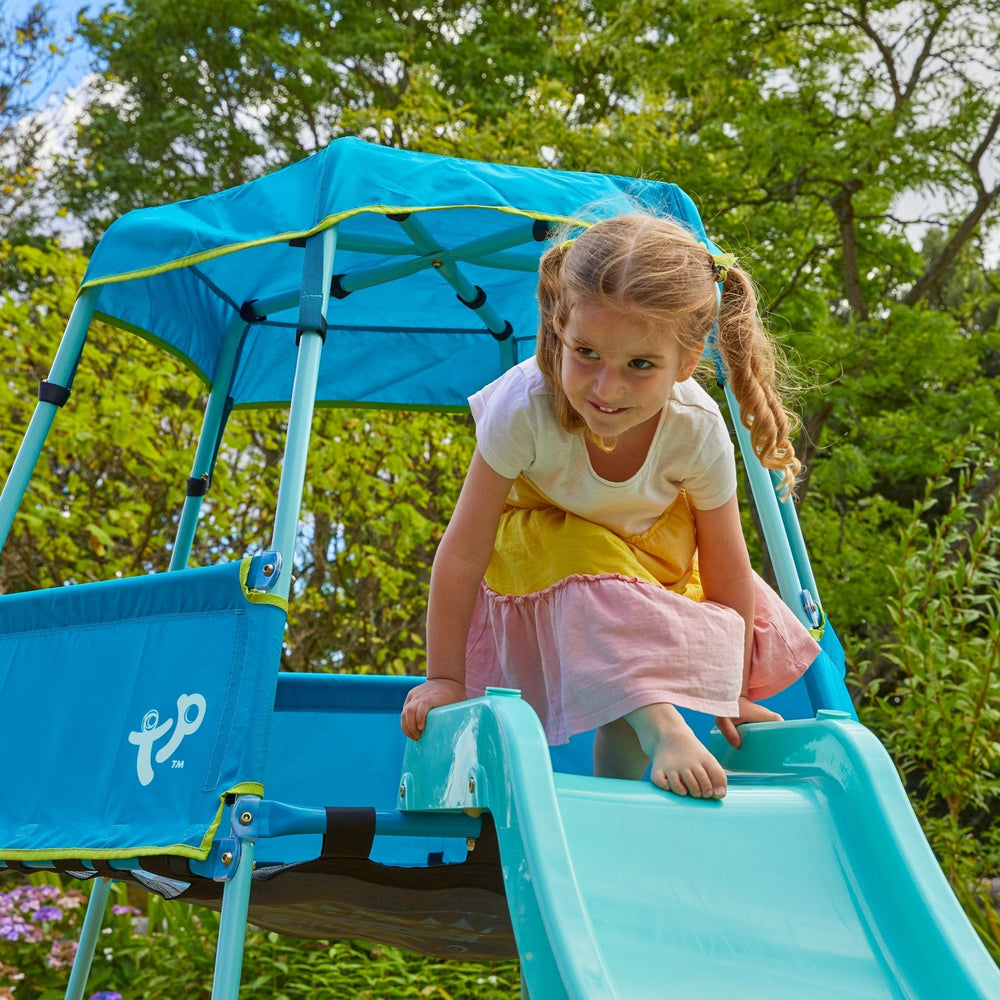 Child playing on plastic garden slide