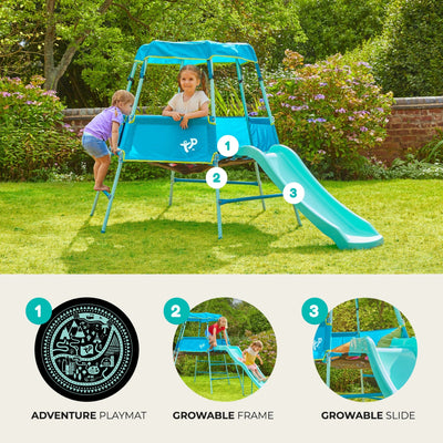 Two children play in the garden on the TP Toys TP Growable Adventurer Metal Climbing Frame, which features an adventure playmat, a growable climbing frame, and a growable slide.