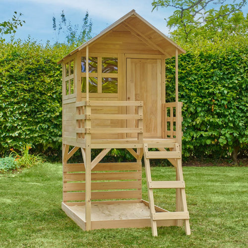 The TP Toys Buttercup Cottage Wooden Playhouse with Verandah and Deck, made from FSC® certified wood, features a small porch, ladder, and open bottom area—perfect for imaginative garden play.