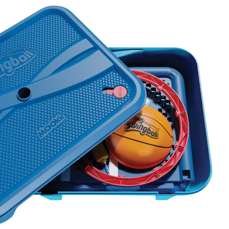 A blue plastic storage box, partially open, contains the TP Toys Basketball All Surface Swingball set with a basketball, red portable hoop, and other sports equipment.