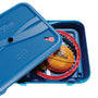 A blue plastic storage box, partially open, contains the TP Toys Basketball All Surface Swingball set with a basketball, red portable hoop, and other sports equipment.