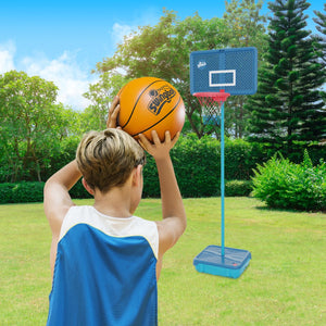 A boy in a blue jersey gets ready to shoot a basketball at a TP Toys Basketball All Surface Swingball hoop set up in the grassy backyard.