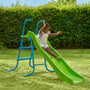 A young child slides down the TP Toys TP 6ft (1.8m) Wavy Slide & Stepset in a grassy backyard garden playground with a hedge in the background.