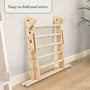 The TP Toys TP Active-Tots Pikler Style Wooden Climbing Triangle, FSC® certified, is folded and placed against a light wall, showing its compact, easy-to-store design—perfect as a Montessori or toddler climbing toy.