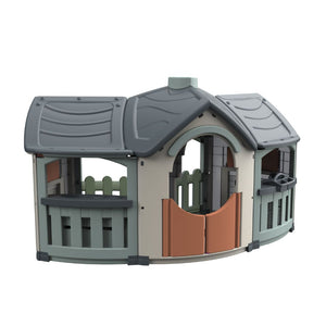 The TP Toys Palplay Grand Villa Plastic Playhouse features a grey roof, arched doorway with orange doors, green fence accents, and multiple open windows—ideal for kids’ imaginative outdoor play.