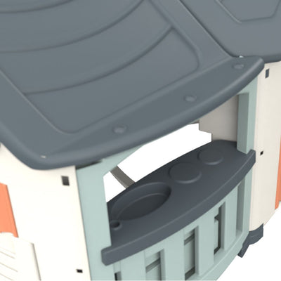 Close-up of the TP Toys Palplay Grand Villa Plastic Playhouse, featuring a grey roof, serving counter with molded details, and light blue and white walls—ideal for imaginative outdoor play.