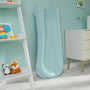 The PalPlay Misty Sky Plastic 4ft Folding Slide by TP Toys, in light blue, is set against a teal wall in a child's room beside a white dresser and a shelf displaying stuffed toys and colorful decor.