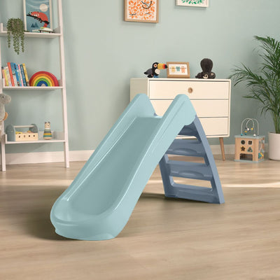 The TP Toys PalPlay Misty Sky Plastic 4ft Folding Slide is shown in a children’s playroom with a wooden floor, toys, plants, and shelves in the background.