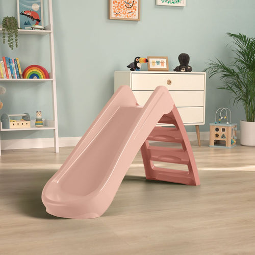 A TP Toys PalPlay Pink Blush Plastic 4ft Folding Slide is set on a light wooden floor in a playroom filled with toys, shelves, and framed pictures on the walls.