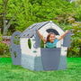 A smiling young child plays with outstretched arms in the TP Toys Palplay Plastic Misty Sky Dream Playhouse, featuring UV resistance and a sunroof, ideal for indoor or outdoor fun on a grassy lawn surrounded by greenery.