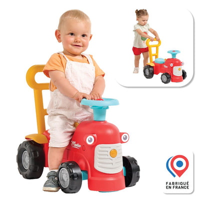 A young child sits on the TP Toys Falk Maurice Vintage Baby Red Tractor, with an inset of another child using the walking aid bar. The Fabriqué en France logo appears in the corner.
