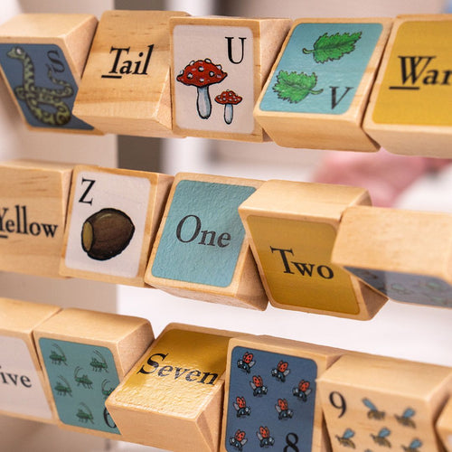 The Gruffalo Wooden Mini Abacus by TP Toys features FSC® certified wooden spinning blocks adorned with charming illustrations, numbers, and words like Tail, Yellow, One, and Seven, as well as images of animals, leaves, mushrooms, and insects. This delightful early learning toy encourages children to build fine motor skills through interactive play—perfect as a companion to your Gruffalo collection or as a stand-alone activity for little hands.