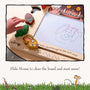 A child draws on The Gruffalo Wooden Magnetic Drawing Board - FSC® certified by TP Toys, with a pen and character pieces beside the partially erased sketch.