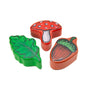 Three wooden toy pieces—a green oak leaf, red mushroom, and acorn—are perfect companions for the TP Toys The Gruffalo Wooden Magnetic Drawing Board - FSC® certified.