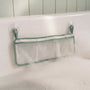 A mesh storage pouch with green edges from TP Toys is attached to a tiled wall above a bathtub using two suction cups. Partially covered by bubbles and filled with The Gruffalo Foam Bath Figures, it keeps bath time toys organized and within easy reach.