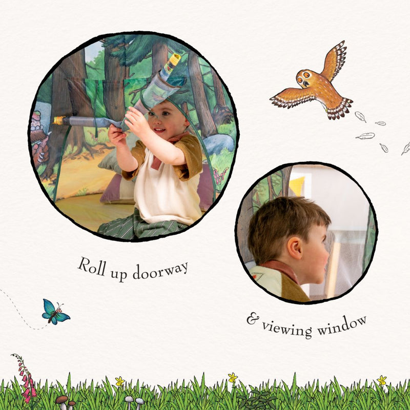 A child sits inside the TP Toys The Gruffalo Play Tent, featuring a roll-up doorway and a small viewing window, holding a telescope and peering out—igniting imaginative play in their very own cosy woodland hideout.