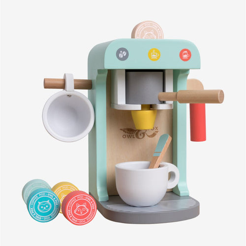 Introducing the Owl & Fox Wooden Coffee Machine by TP Toys—a pastel-colored playset made from FSC® certified wood. This set includes a charming wooden coffee machine, two cups, a spoon, and several colorful pretend coffee pods—perfect for pretend play and Montessori toy collections.