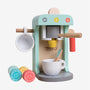 Introducing the Owl & Fox Wooden Coffee Machine by TP Toys—a pastel-colored playset made from FSC® certified wood. This set includes a charming wooden coffee machine, two cups, a spoon, and several colorful pretend coffee pods—perfect for pretend play and Montessori toy collections.