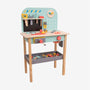 The Owl & Fox Wooden Workbench Set by TP Toys is an FSC® certified children’s workbench that includes a full tool set—hammer, wrench, screwdriver, and a variety of colorful pieces—neatly organized on and below the table, making it perfect for imaginative pretend play.