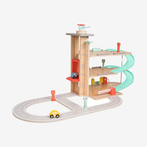 The TP Toys Owl & Fox Wooden Multi-storey Garage - FSC® certified features three levels, a spiral ramp, a helicopter pad, two toy cars, a helicopter, and tracks with road signs, all set against a white background. This Montessori-inspired wooden car garage fosters imaginative pretend play while supporting the development of motor skills and creativity.