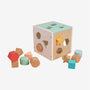 Pastel-colored and charming, the Owl & Fox Wooden Shape Sorter - FSC® certified from TP Toys features geometric blocks—such as stars, hexagons, and circles—some neatly inserted while others are scattered playfully around the wooden activity cube.