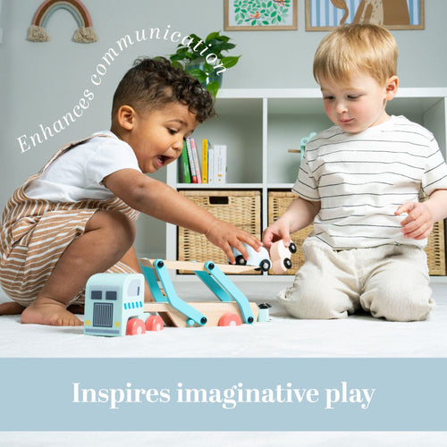 Two young children sit on a carpeted floor, playing with the TP Toys Owl & Fox Wooden Vehicle Transporter - FSC® certified. Text on image reads: Enhances communication and inspires imaginative play.