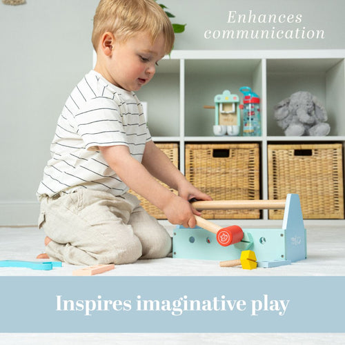 A young child sits on the floor playing with a TP Toys Owl & Fox Wooden Tool Caddy - FSC® certified, with shelves and baskets in the background. Text reads: Enhances communication and inspires imaginative play.