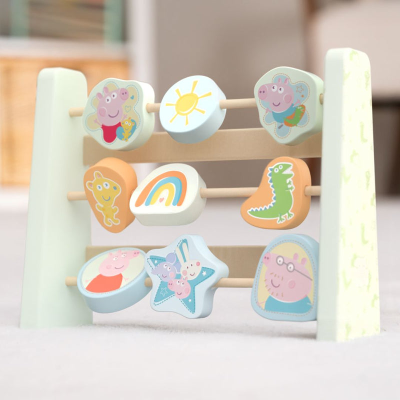 The TP Toys Grow With Peppa Pig Wooden Abacus has three rows of colorful spinning blocks with characters, a sun, and a rainbow—great for sensory play and developing fine motor skills.