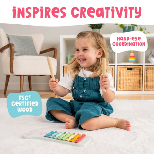 A young child plays the TP Toys Grow With Peppa Pig Wooden Xylophone—crafted from FSC certified wood with mallets—developing creativity, hand-eye coordination, and early musical skills.