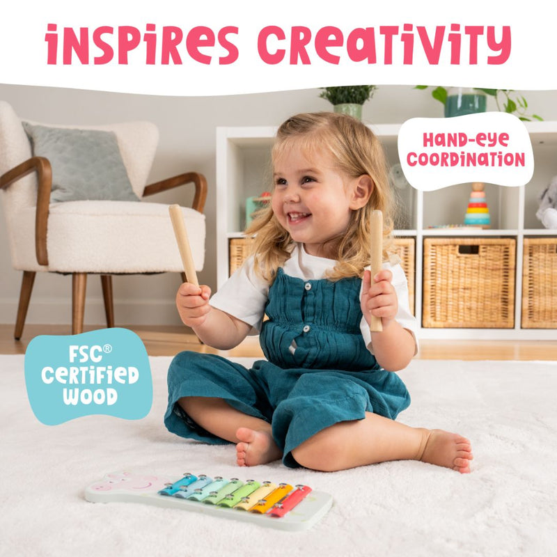 A young child plays the TP Toys Grow With Peppa Pig Wooden Xylophone—crafted from FSC certified wood with mallets—developing creativity, hand-eye coordination, and early musical skills.