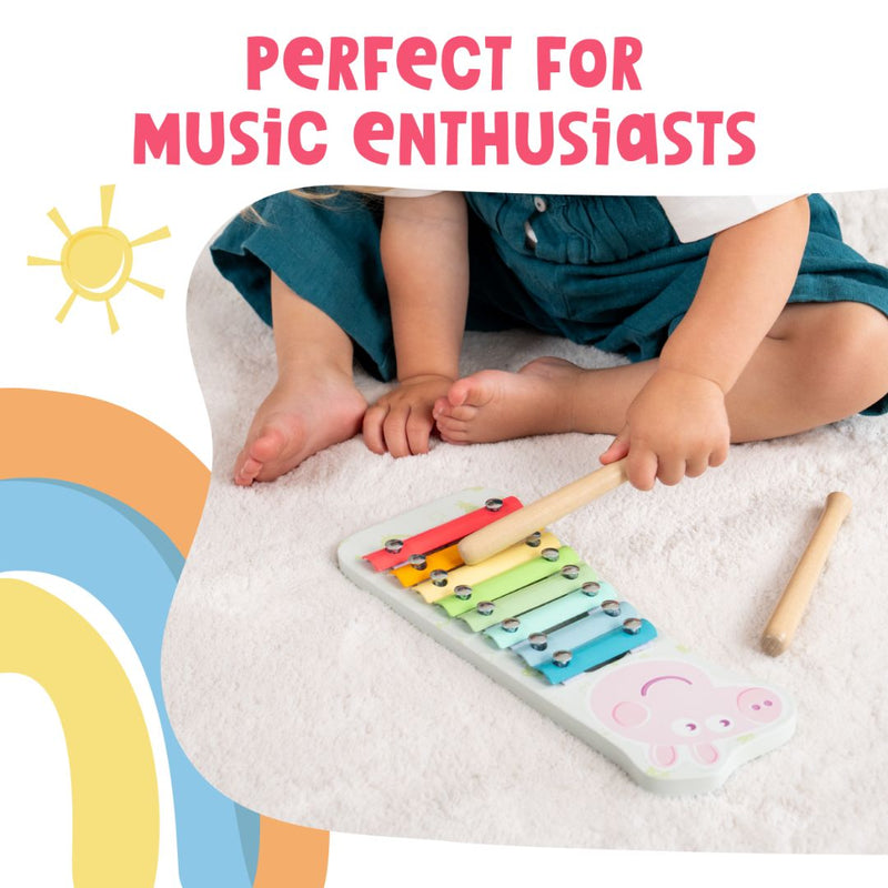 A child sits on a white carpet playing the colorful Grow With Peppa Pig Wooden Xylophone by TP Toys. Text above says: Perfect for early musical skills and young music fans.