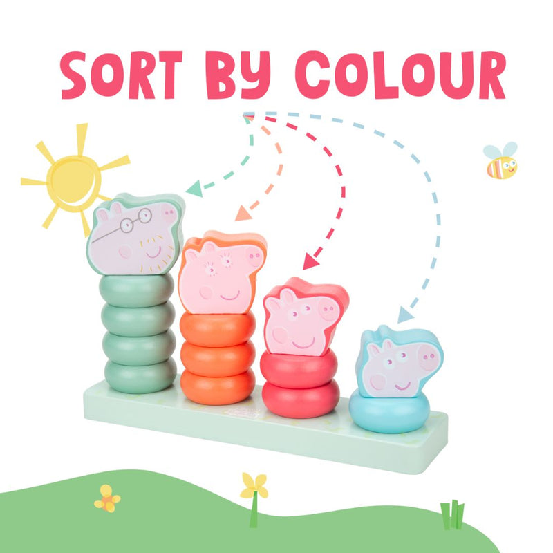 The Grow with Peppa Pig Wooden Family Ring Stacker by TP Toys features four colorful stacks with animal faces on a base labeled SORT BY COLOUR, set against a playful sun, bee, and grass background—ideal for developing fine motor skills.