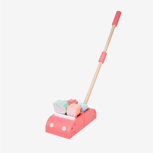 The TP Toys Grow with Peppa Pig Wooden Push Along Family Car is a pink wooden push toy featuring a handle and three delightful Peppa Pig family figures on top, thoughtfully designed for young children to encourage gross motor development.
