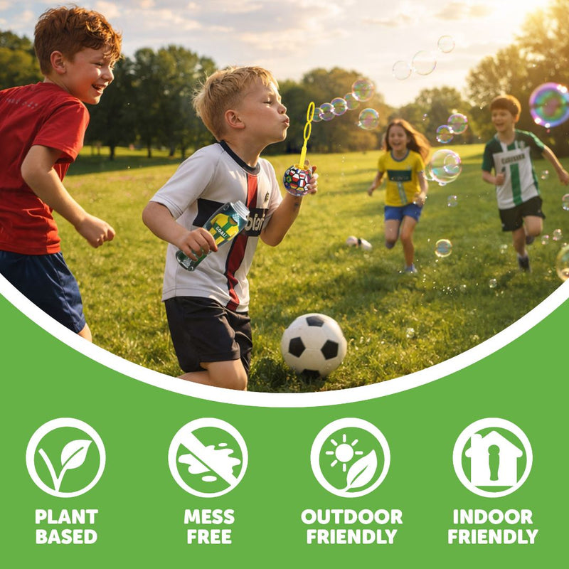 Four children play with bubbles and a soccer ball on the grass in a park, having fun with TP Toys’ The Unspillable Bubbles – Football Edition. Icons below highlight that this plant-based product offers mess-free, unspillable bubbles in a no-spill tube and is perfect for both indoor and outdoor play.