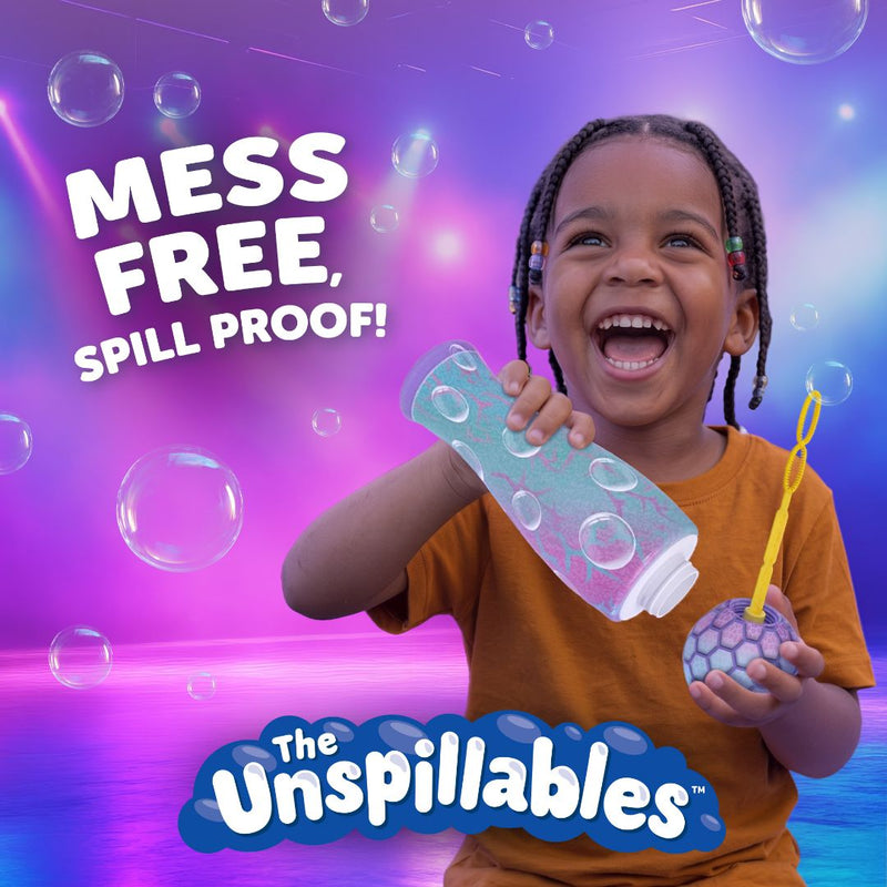 A smiling child in an orange shirt holds The Unspillable Bubbles – Popstar Edition from TP Toys, featuring a bubble tube and a spill-proof container. Bold text reads “MESS FREE, SPILL PROOF!” and “The Unspillables” against a vibrant bubbly background, promising truly mess-free bubble fun.
