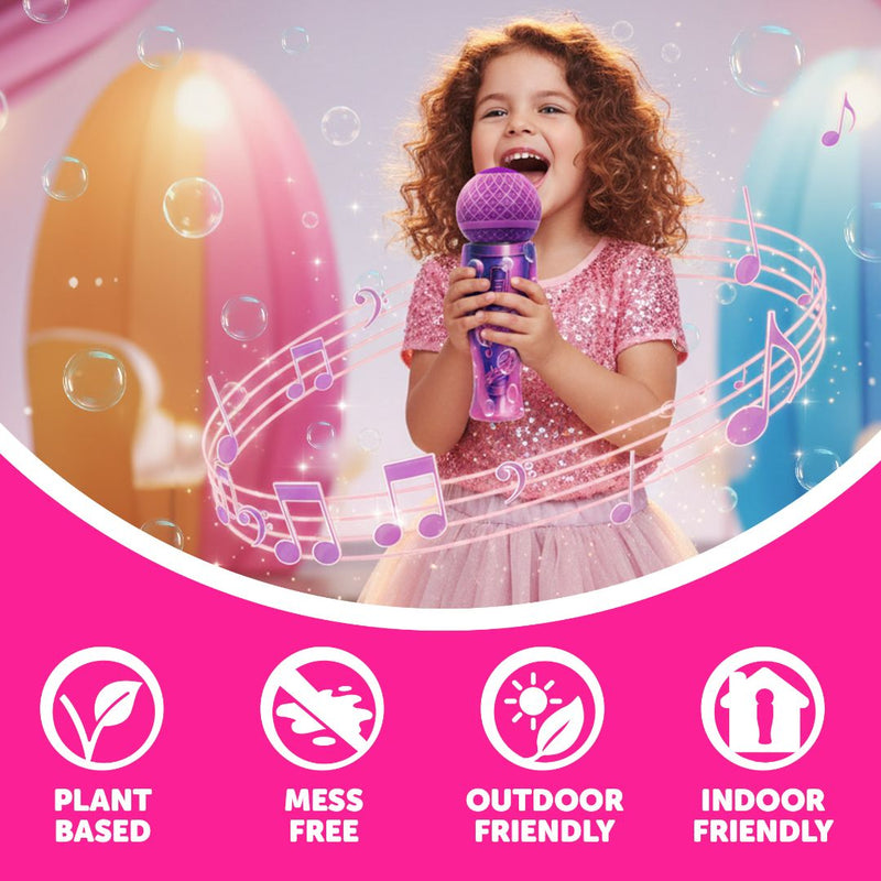 A young girl in a pink dress sings into a toy microphone, surrounded by bubbles from her TP Toys The Unspillable Bubbles – Popstar Edition bubble tube, with icons below showcasing its plant-based formula, no-spill design, and suitability for both indoor and outdoor play.