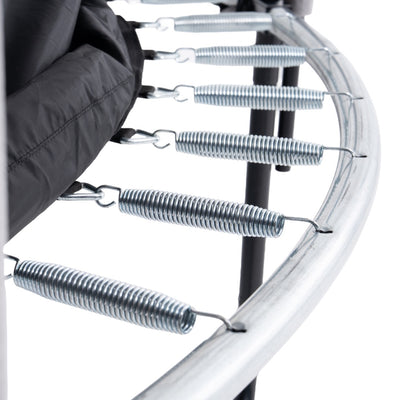 Close-up of metal springs attached to the galvanized steel frame of the TP Genius® 10ft Round Trampoline by TP Toys, with part of the black jumping mat visible—showcasing its durable construction.