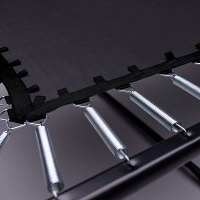 Close-up of the TP Infinity 10ft x 14ft Rectangular Trampoline by TP Toys, showing the black jumping mat attached to metal springs and a sturdy black frame designed for easy assembly.