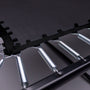 Close-up of the TP Infinity 10ft x 14ft Rectangular Trampoline by TP Toys, showing the black jumping mat attached to metal springs and a sturdy black frame designed for easy assembly.