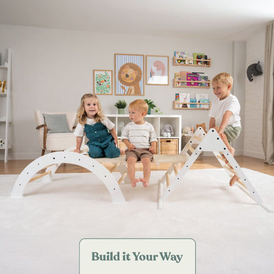 Three young children play on the TP Active-Tots Pikler Style Three in One Playset by TP Toys, an FSC® certified product, in a bright, organized playroom decorated with animal themes and shelves in the background.