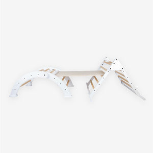 The TP Toys TP Active-Tots Pikler Style Three in One Playset - FSC® certified features a white arch, ramp, and triangle frame, offering a stylish and safe wooden indoor climbing set for children. Inspired by Montessori principles, this playset encourages active play and healthy development, making it a perfect choice for toddlers to explore and grow.