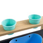 Two light blue plastic cups sit in holes on the Bluey Little Chef Wooden Mud Kitchen by TP Toys—an FSC® certified playset perfect for imaginative outdoor fun.