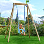 A baby smiles in the TP Toys TP Forest Wooden Single Swing with Bluey Quadpod - FSC® certified, set up on grass amid trees and flowers.