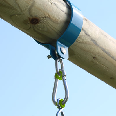 A TP Toys Sherwood Single Wooden Swing Set with Bluey Quadpod (PEFC certified) features a metal bracket securing the wooden beam, with a carabiner clip attached, all set against a clear blue sky.