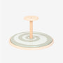 The TP Toys TP Active-Tots Pikler Style Wooden Spinning Seat - FSC® certified features a painted wooden construction with a central handle and a circular base adorned with concentric rings on a light background, making it an ideal Montessori-inspired toddler toy to encourage sensory play.